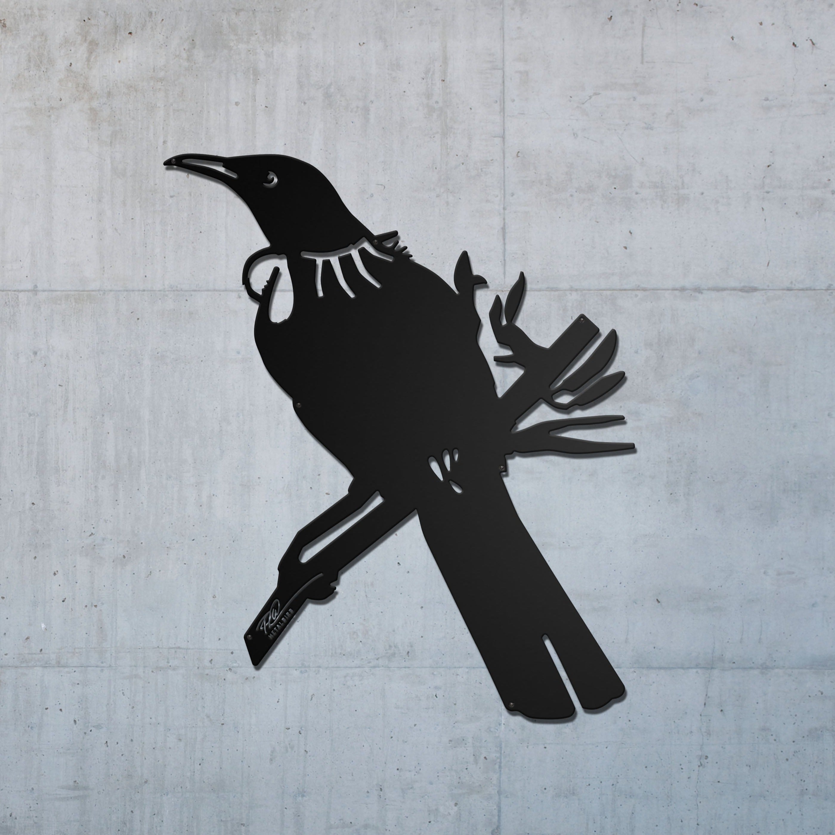 The Tūī Big Bird Wall Sculpture by Metalbird New Zealand is a premium black metal silhouette of a tūī perched on a branch, with a tuft and “TĒNĀ KOE” sign—a striking gift for any plain wall.