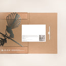 The Pīwakawaka Mum & Mini Set by Metalbird New Zealand features a minimalist brown folder with a cutout metal piwakawaka on a branch—an ideal, uniquely Kiwi Mother’s Day gift. Includes white card with text and black-and-white photo.