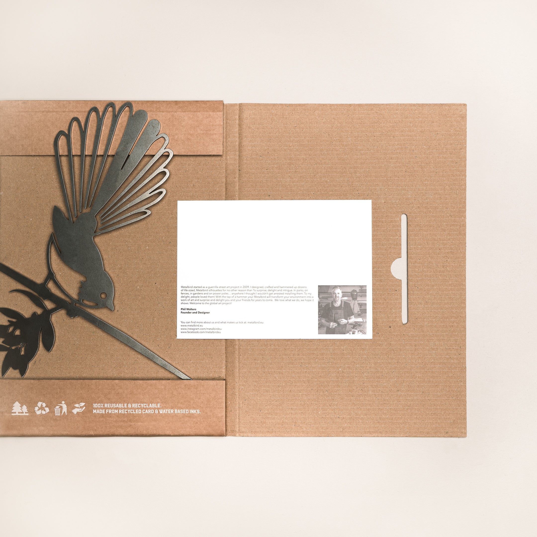 The Pīwakawaka Mum & Mini Set by Metalbird New Zealand features a minimalist brown folder with a cutout metal piwakawaka on a branch—an ideal, uniquely Kiwi Mother’s Day gift. Includes white card with text and black-and-white photo.