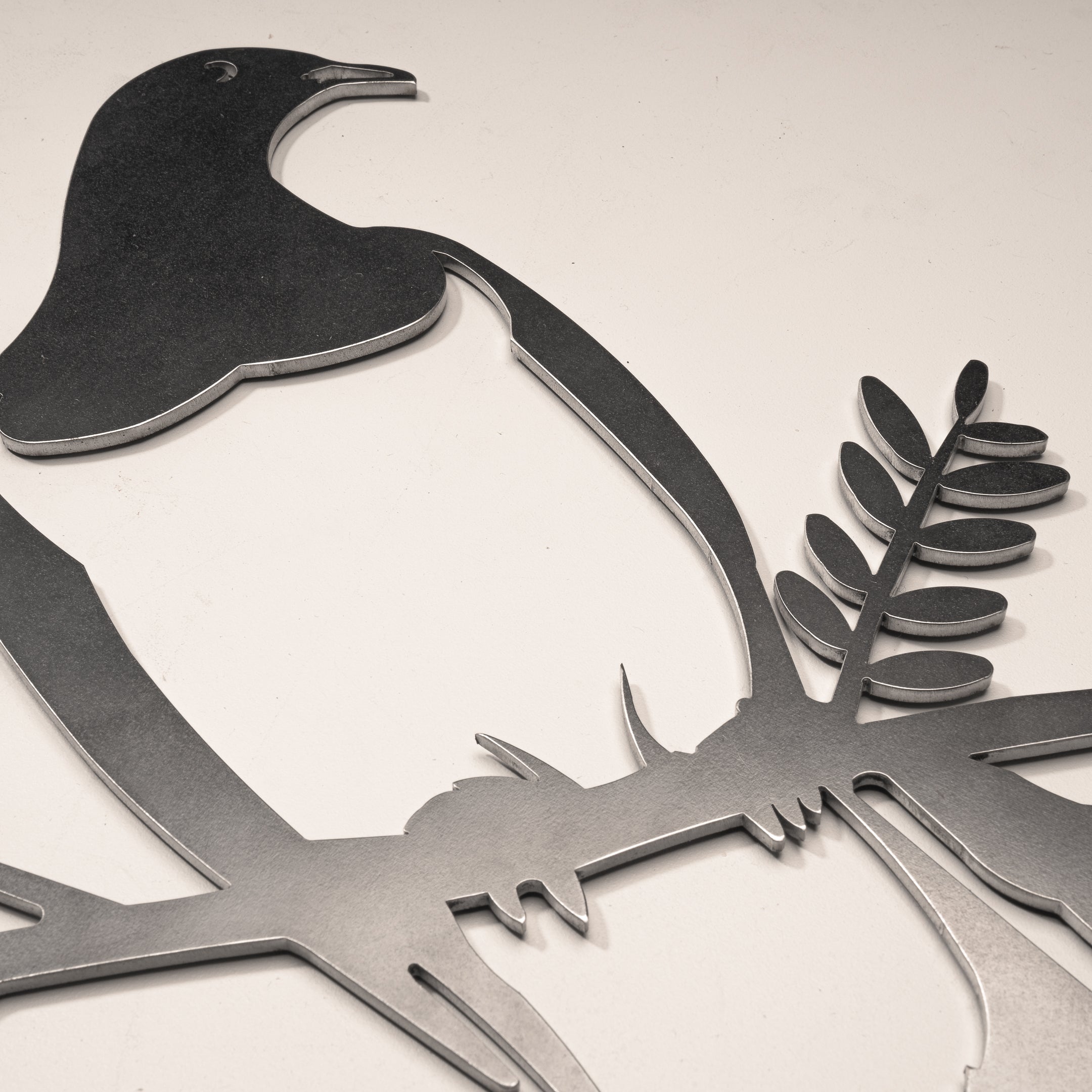 The Kererū Mum & Mini Set by Metalbird New Zealand features a metal cutout of two kererū birds on a branch—its minimalist design and smooth edges make it a unique Mother's Day gift.