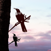 The Tūī Mum & Mini Set by Metalbird New Zealand features two metal bird silhouettes perched on branches, forming a striking garden sculpture—an ideal Mother's Day gift with their bold shapes against the sky.