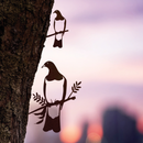 The Kererū Mum & Mini Set by Metalbird New Zealand features two metal bird silhouettes perched on branches against a sunset cityscape—a unique Mother's Day gift idea.