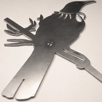 The Tūī Mum & Mini Set by Metalbird New Zealand features a metal silhouette of a Tūī mum and baby, perched on a branch with feather and eye cut-outs—an ideal Mother's Day garden sculpture for any light surface.