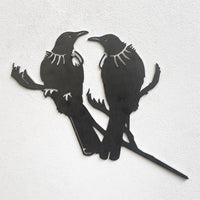 The metalbird Metalbird Seconds - PIWAKAWAKA AND BABY - XL features two birds with white throat tufts on branches. Offered at a discount due to minor flaws, this wall art’s unique design and charm from metalbird remain unaffected.