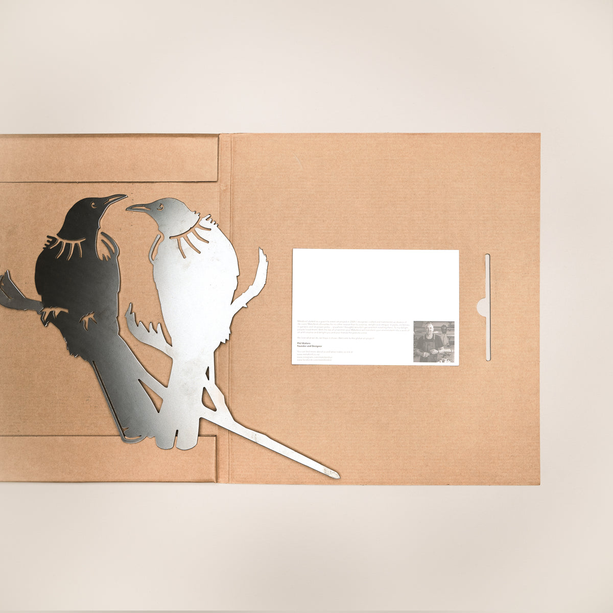 Tūī Twosome silhouette beside opened Metalbird packaging and printed card.