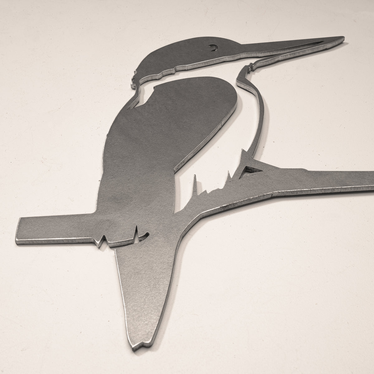 Close-up of the Kōtare beak and wing cutouts in steel.
