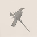 Flat-lay of Tui bird silhouette cut from raw Corten steel, highlighting clean edges and elegant handcrafted detailing