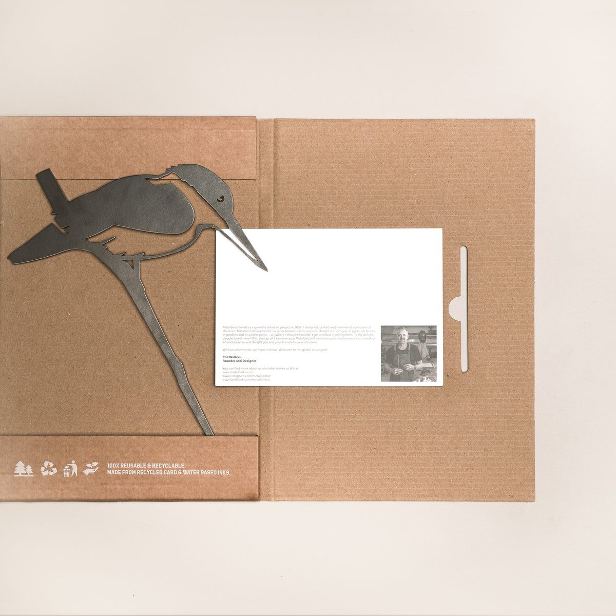 Kōtare silhouette beside opened Metalbird packaging and printed card.