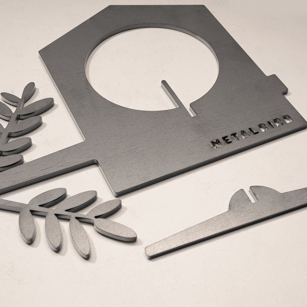 Close-up of the steel Bird Feeder body and separate slide-in perch.