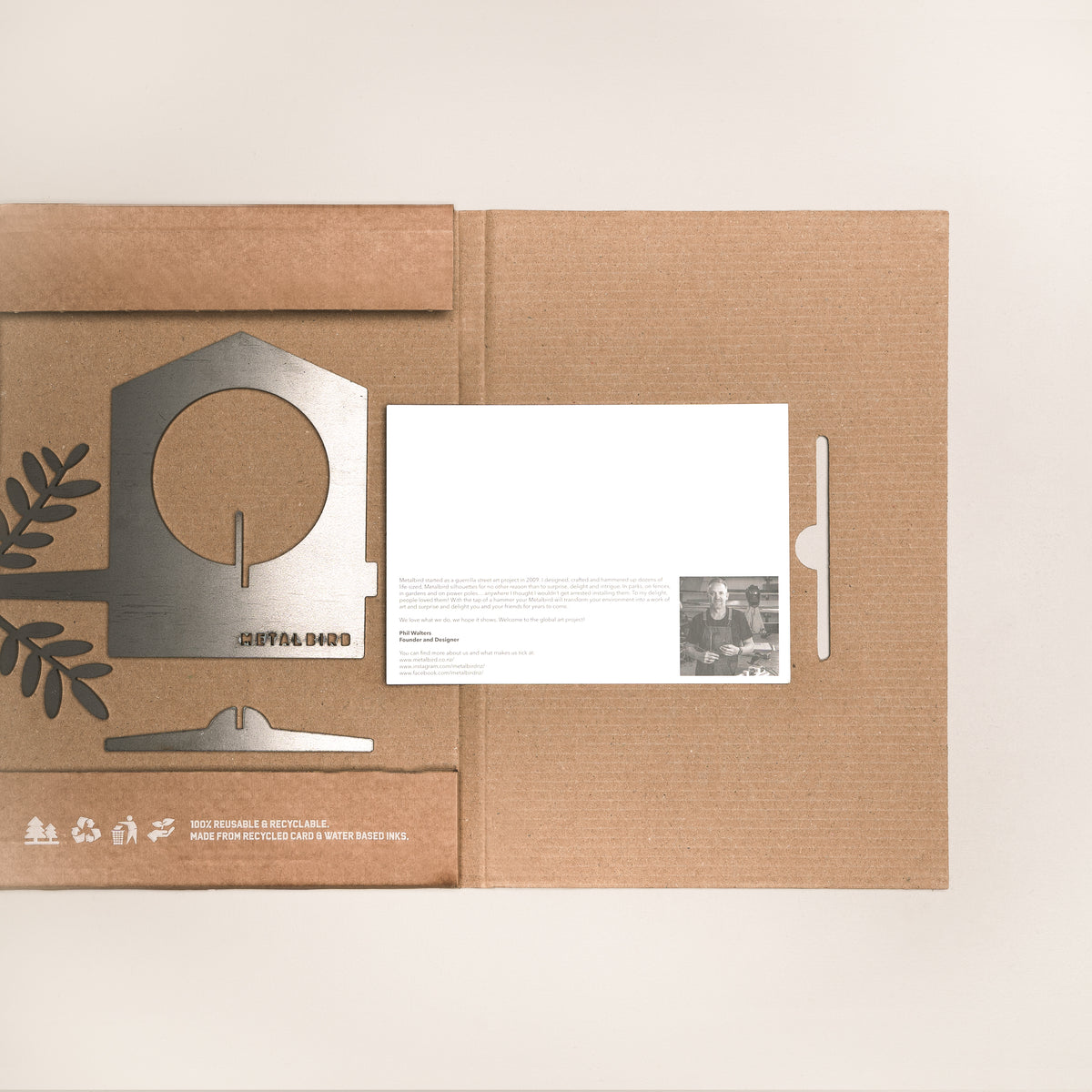 Bird Feeder beside opened Metalbird packaging and printed card.