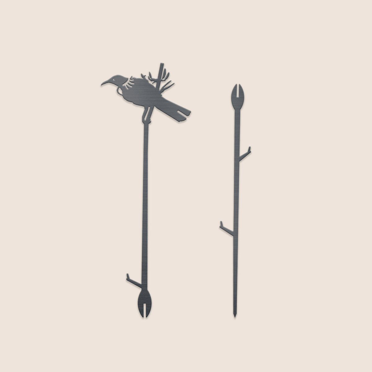 The Metalbird New Zealand Tūī Plant Stake (70cm) features a striking bird-on-branch silhouette, crafted in a minimalistic style—an elegant accent for your garden, presented on a light background.